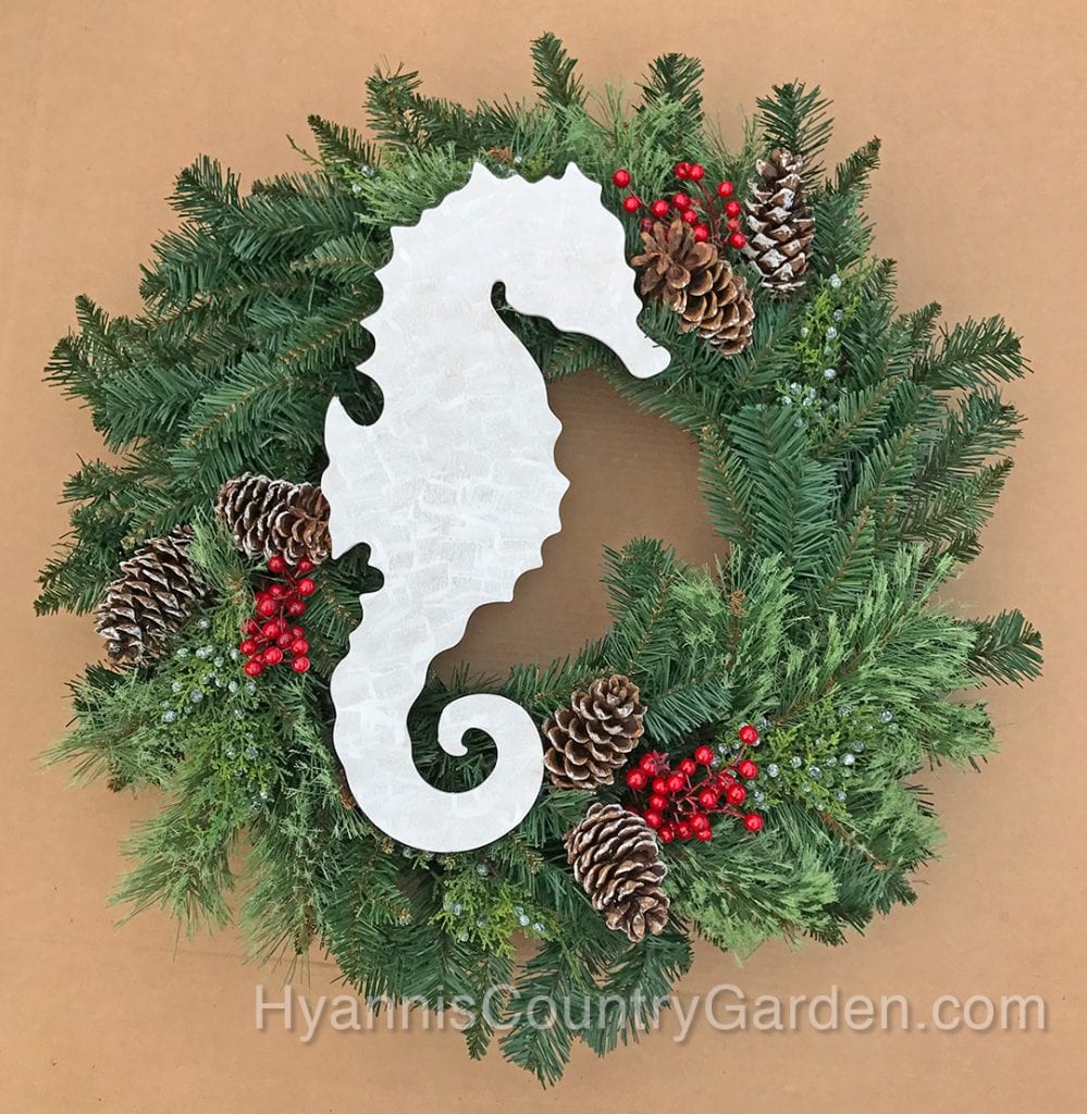 The seahorse might end up with a red ribbon around his neck and a bow on his side. I might also add some white sprays in this wreath to balance out the large expanse of white on the seahorse.